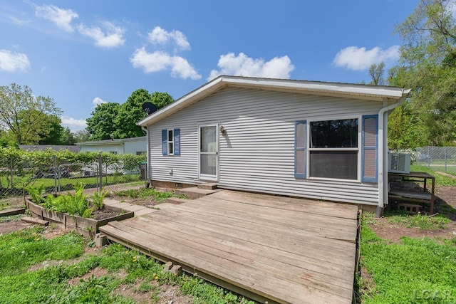 943 Howell Ave, Adrian, MI 49221 - back of property with a wooden deck, fence, and crawl space