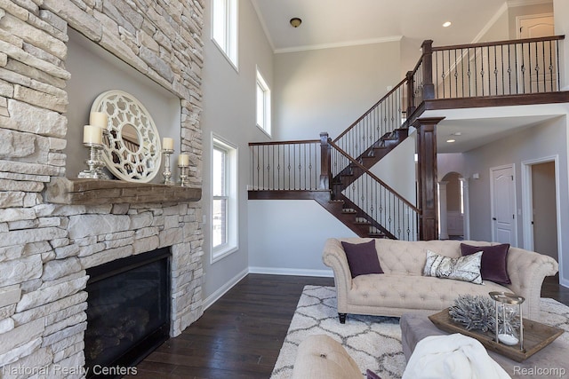 7118 Oak Ridge Ct, Clarkston, MI 48348 - living area featuring stairs, a stone fireplace, baseboards, wood finished floors, and a high ceiling