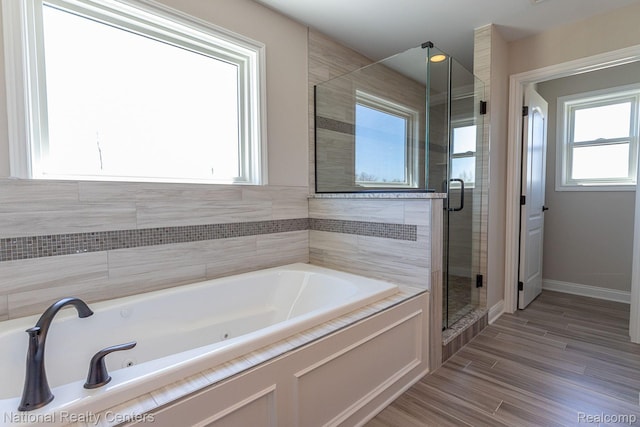 7118 Oak Ridge Ct, Clarkston, MI 48348 - full bathroom with a whirlpool tub, a shower stall, wood finished floors, and baseboards