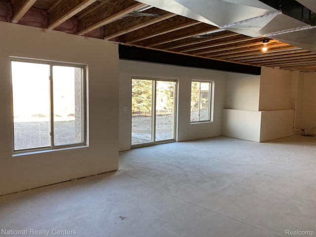 7118 Oak Ridge Ct, Clarkston, MI 48348 - spare room with concrete floors