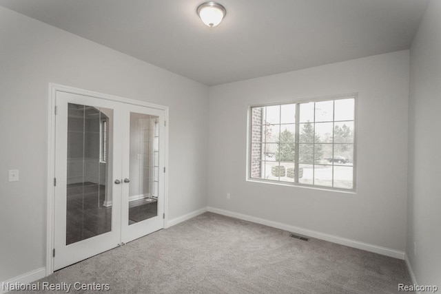 7118 Oak Ridge Ct, Clarkston, MI 48348 - unfurnished bedroom with french doors, carpet floors, and baseboards
