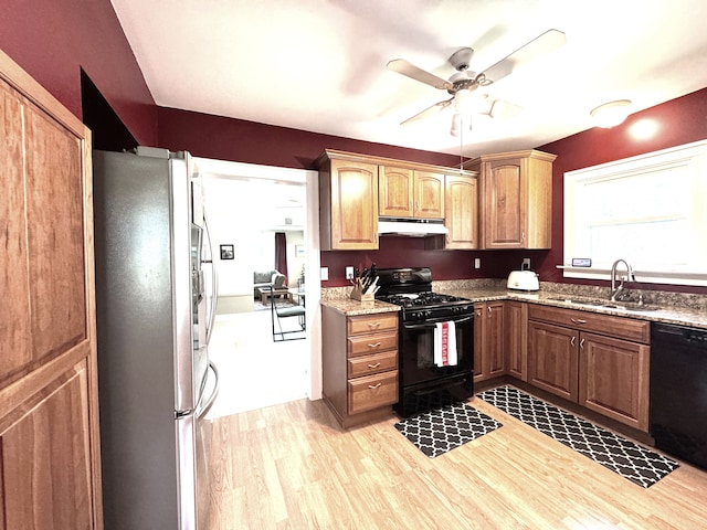 25220 Code Rd, Southfield, MI 48033 - kitchen with black appliances, a sink, under cabinet range hood, light wood finished floors, and a ceiling fan