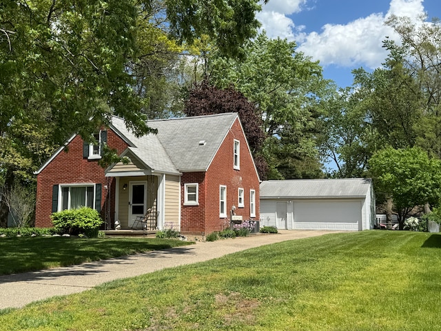 25220 Code Rd, Southfield, MI 48033 - view of front of home featuring an outdoor structure, a front lawn, a detached garage, and brick siding