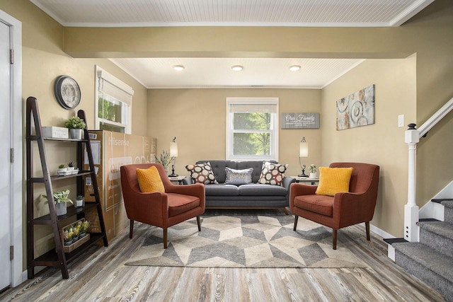 living room featuring wood finished floors, stairs, healthy amount of natural light, crown molding, and recessed lighting