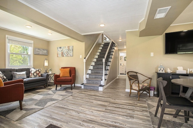 living room featuring stairs, light wood-type flooring, baseboards, and recessed lighting