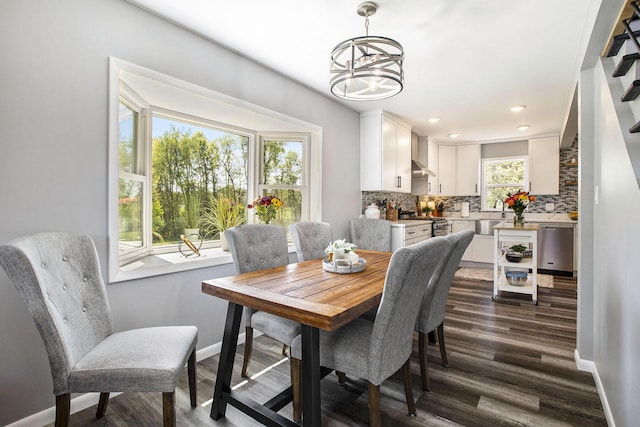dining room featuring dark wood-style flooring, a chandelier, baseboards, and recessed lighting