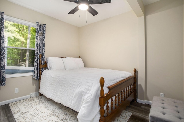 bedroom with baseboards, wood finished floors, and a ceiling fan