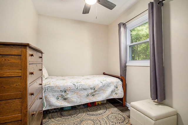 bedroom featuring wood finished floors, a ceiling fan, and baseboards