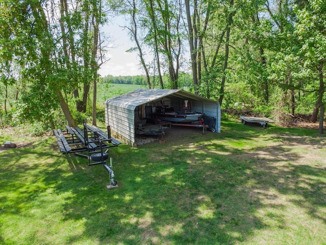 view of green lawn featuring a carport