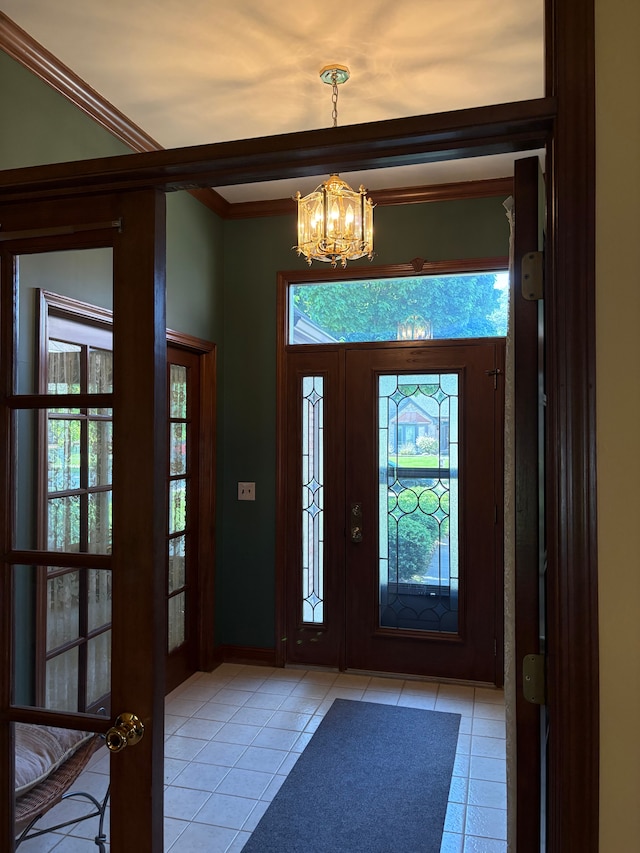 39858 Wilmette Dr, Sterling Heights, MI 48313 - entryway with light tile patterned floors, a chandelier, healthy amount of natural light, and crown molding