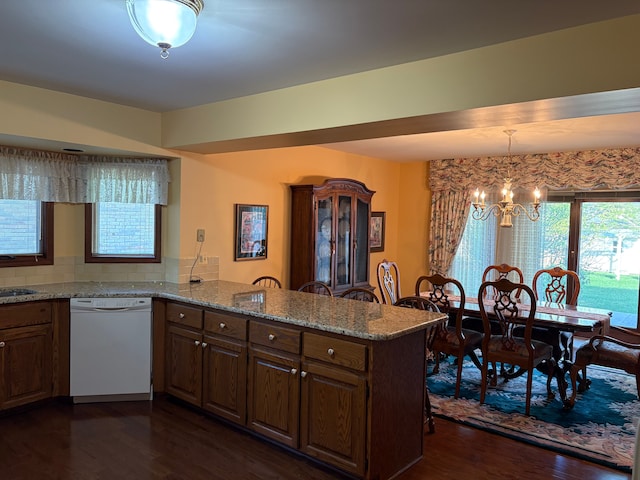 39858 Wilmette Dr, Sterling Heights, MI 48313 - kitchen with white dishwasher, a peninsula, dark wood-style flooring, a chandelier, and light stone countertops
