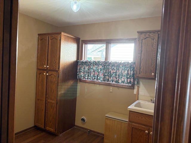 39858 Wilmette Dr, Sterling Heights, MI 48313 - laundry area featuring dark wood-style floors, cabinet space, and baseboards