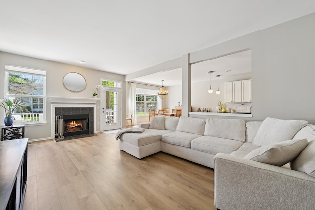5639 Heathland Cir, Clarkston, MI 48346 - living room with light wood-type flooring, plenty of natural light, and a fireplace