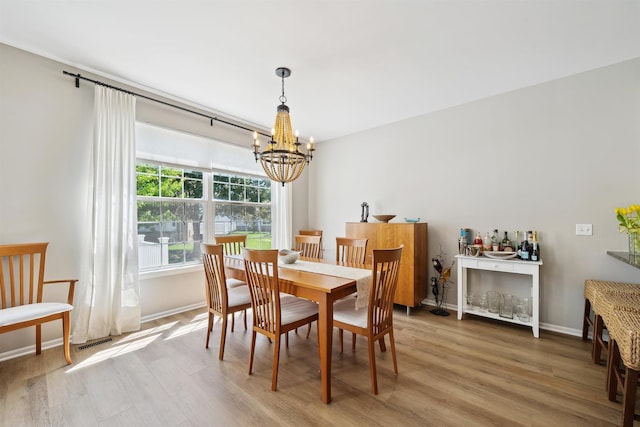 5639 Heathland Cir, Clarkston, MI 48346 - dining space featuring a chandelier, light wood-style flooring, and baseboards