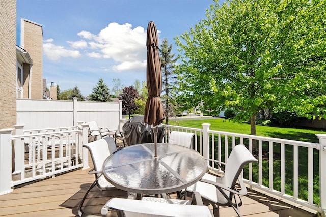 5639 Heathland Cir, Clarkston, MI 48346 - wooden deck featuring outdoor dining area and a lawn