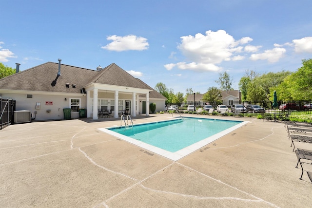 5639 Heathland Cir, Clarkston, MI 48346 - community pool with fence, a patio area, and cooling unit