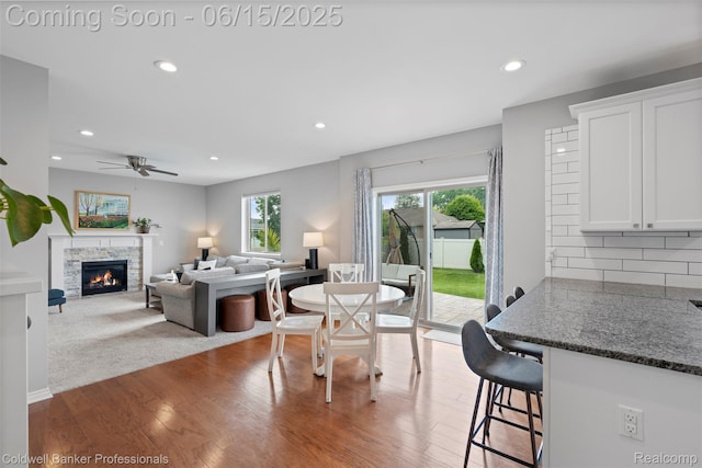 52851 Schafers Run Ct, Chesterfield, MI 48051 - dining area featuring healthy amount of natural light, a stone fireplace, recessed lighting, wood finished floors, and a ceiling fan