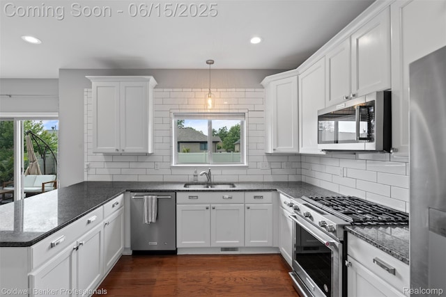 52851 Schafers Run Ct, Chesterfield, MI 48051 - kitchen featuring appliances with stainless steel finishes, a peninsula, recessed lighting, white cabinetry, and tasteful backsplash