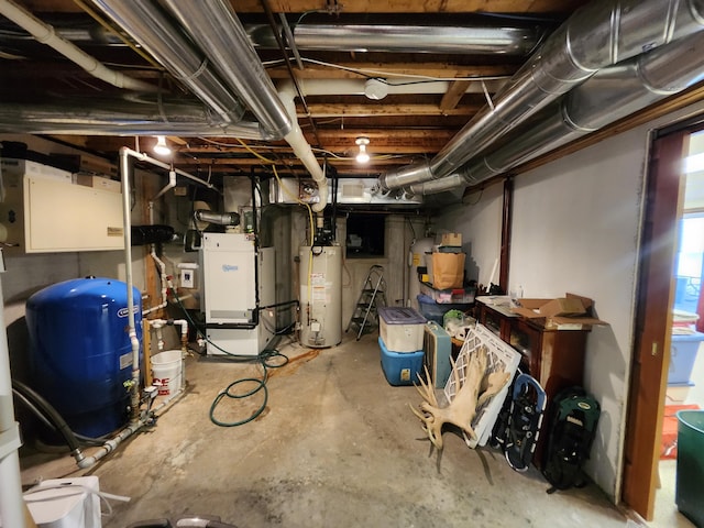 5005 S Brye Rd, Ludington, MI 49431 - below grade area with water heater, a water pressure tank, and heating unit