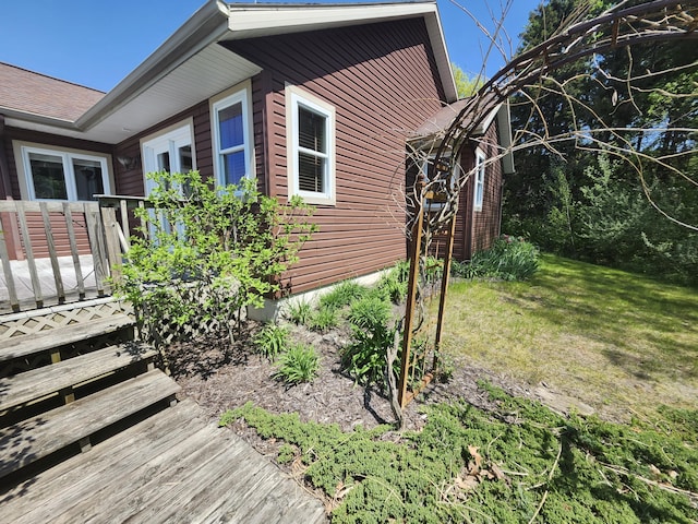 5005 S Brye Rd, Ludington, MI 49431 - view of side of home featuring a yard and a deck