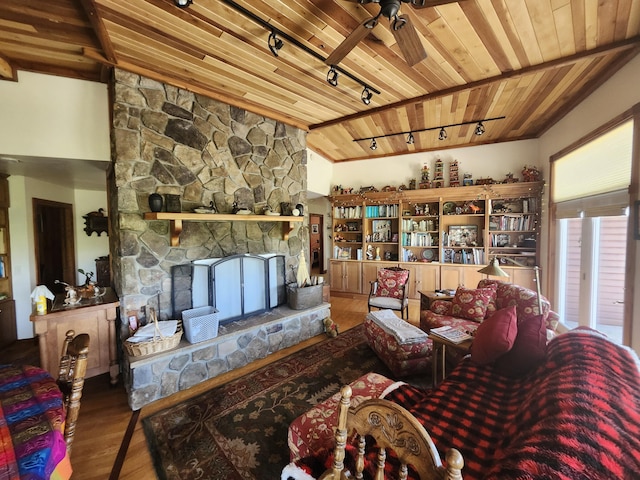 5005 S Brye Rd, Ludington, MI 49431 - living area with wood ceiling, rail lighting, wood finished floors, ceiling fan, and a stone fireplace
