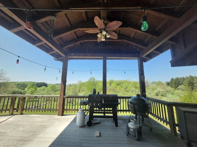 5005 S Brye Rd, Ludington, MI 49431 - wooden deck featuring a gazebo, a ceiling fan, a wooded view, and a grill
