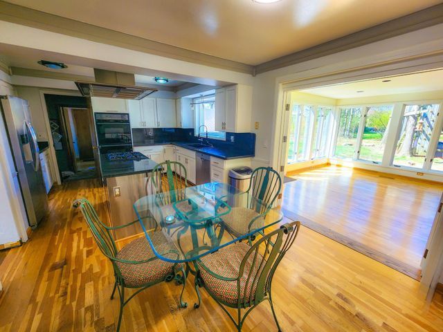 5130 Lake Bluff Rd, West Bloomfield, MI 48323 - dining space with light wood-type flooring