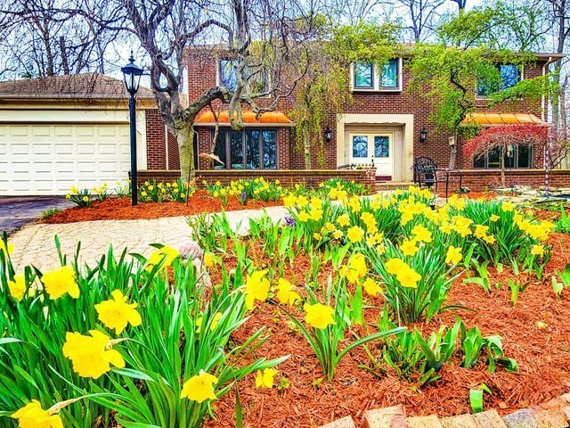 5130 Lake Bluff Rd, West Bloomfield, MI 48323 - view of front of home with brick siding, driveway, and a garage