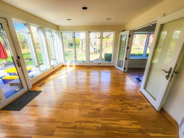 5130 Lake Bluff Rd, West Bloomfield, MI 48323 - unfurnished sunroom with wood finished floors, plenty of natural light, french doors, and recessed lighting