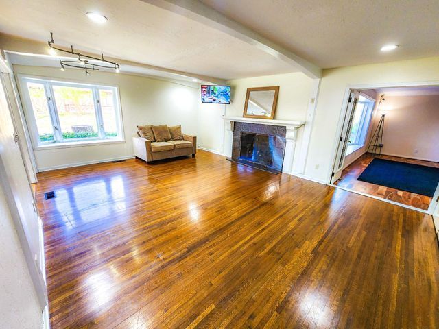 5130 Lake Bluff Rd, West Bloomfield, MI 48323 - living area with wood finished floors, a fireplace, baseboards, and recessed lighting
