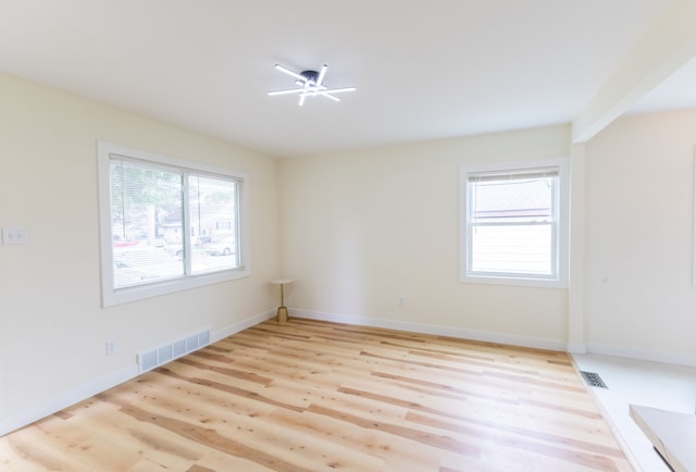 27396 Beechurst St, Roseville, MI 48066 - empty room featuring healthy amount of natural light, light wood-style floors, and baseboards