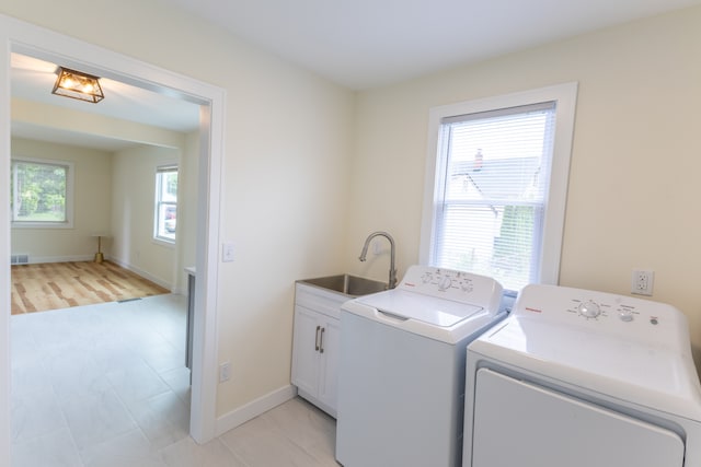27396 Beechurst St, Roseville, MI 48066 - washroom featuring washing machine and dryer, cabinet space, and baseboards