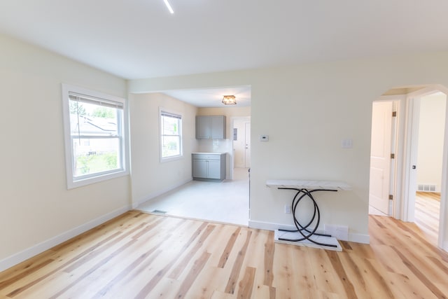 27396 Beechurst St, Roseville, MI 48066 - unfurnished room with arched walkways, light wood-style floors, and baseboards