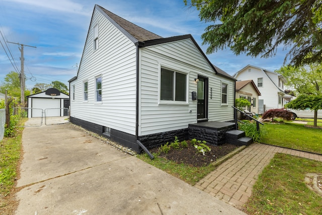 27396 Beechurst St, Roseville, MI 48066 - view of front of home with a detached garage, a gate, concrete driveway, and an outbuilding
