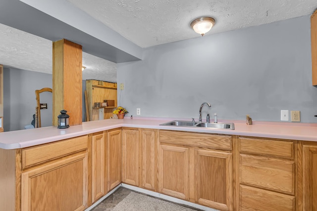 8595 Rives Junction Rd, Rives Junction, MI 49277 - kitchen featuring a sink, a textured ceiling, a peninsula, and light countertops