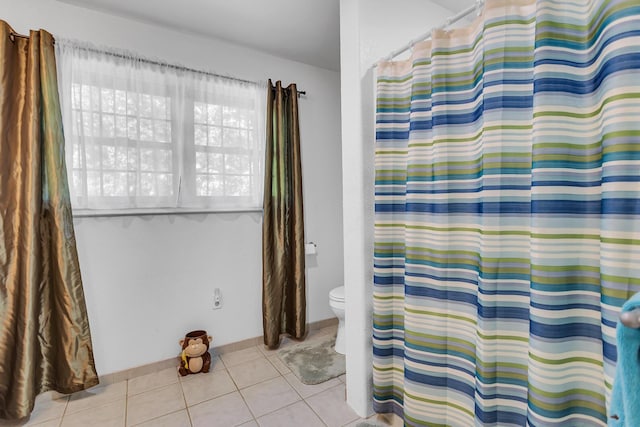 8595 Rives Junction Rd, Rives Junction, MI 49277 - bathroom with tile patterned floors, toilet, a shower with curtain, and baseboards
