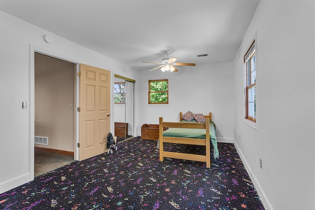 8595 Rives Junction Rd, Rives Junction, MI 49277 - carpeted bedroom with baseboards, ceiling fan, and a closet