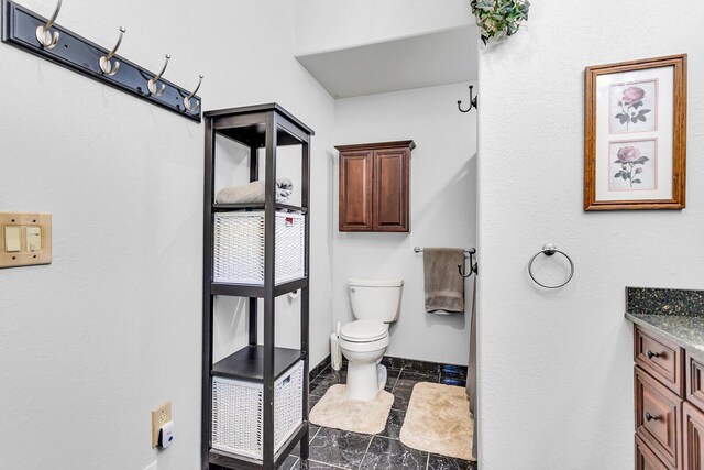 8595 Rives Junction Rd, Rives Junction, MI 49277 - bathroom with vanity, toilet, baseboards, and marble finish floors