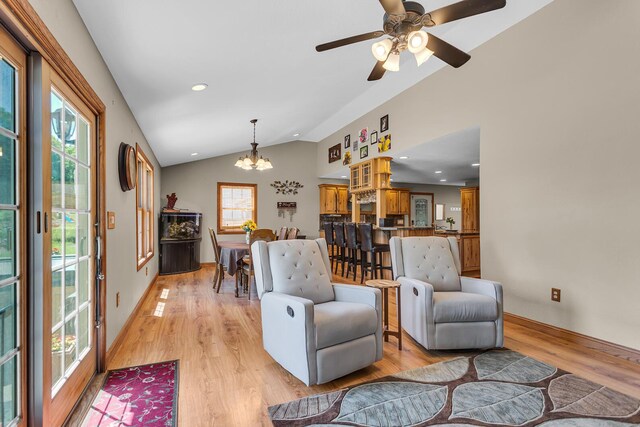 8595 Rives Junction Rd, Rives Junction, MI 49277 - living room with a chandelier, plenty of natural light, lofted ceiling, light wood-style flooring, and baseboards