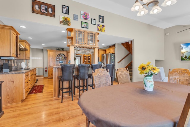 8595 Rives Junction Rd, Rives Junction, MI 49277 - dining area featuring a chandelier, light wood finished floors, stairs, recessed lighting, and a towering ceiling