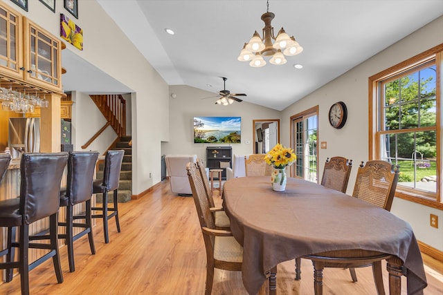 8595 Rives Junction Rd, Rives Junction, MI 49277 - dining area featuring light wood finished floors, a chandelier, lofted ceiling, ceiling fan, and stairs