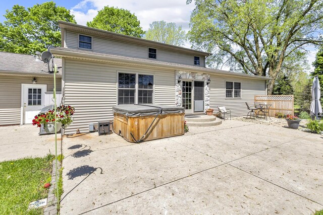 8595 Rives Junction Rd, Rives Junction, MI 49277 - rear view of house featuring a hot tub and a patio area