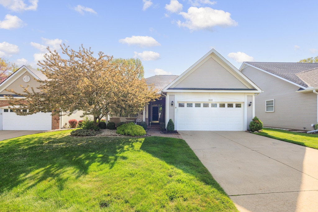 3618 Camden Ct, Auburn Hills, MI 48326 - view of front of house featuring an attached garage, concrete driveway, and a front lawn