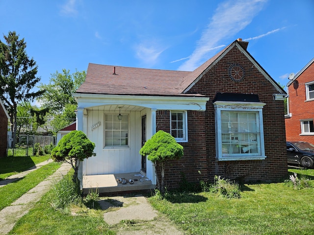 10773 Beaconsfield St, Detroit, MI 48224 - bungalow-style home with brick siding and board and batten siding