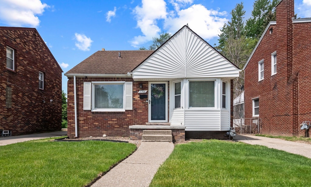 7701 Dacosta, Detroit, MI 48239 - bungalow featuring a front yard, a shingled roof, and brick siding