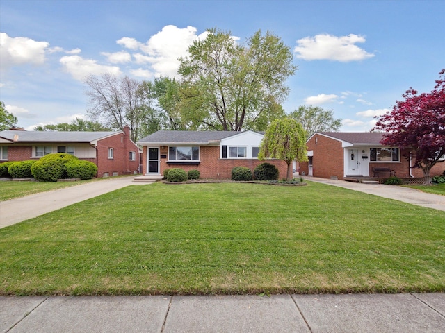 21000 Saint Gertrude St, Saint Clair Shores, MI 48081 - ranch-style house featuring driveway, brick siding, a front yard, and entry steps