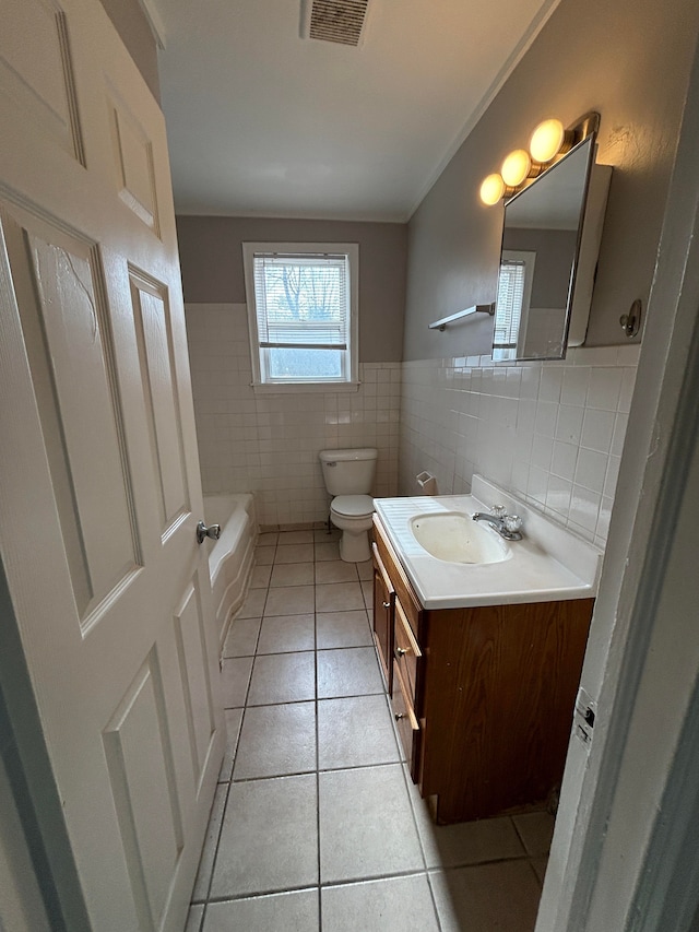 full bathroom featuring tile patterned flooring, tile walls, a bath, vanity, and toilet