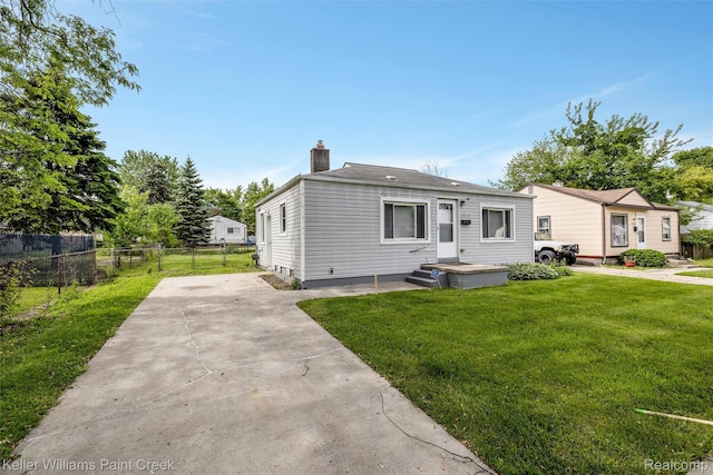13350 Sidonie Ave, Warren, MI 48089 - view of front of home with a chimney and driveway