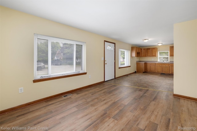 13350 Sidonie Ave, Warren, MI 48089 - unfurnished living room with dark wood-style floors, baseboards, and a sink