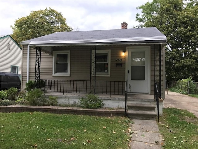 18989 Washtenaw St, Harper Woods, MI 48225 - view of front of house featuring a porch and a chimney